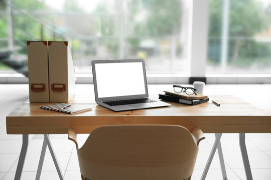 Workplace with laptop in front of window