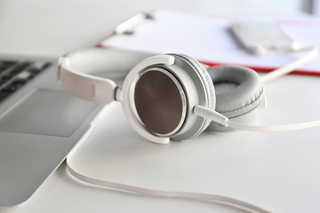 Obraz na płótnie Canvas Headphones and laptop on office table