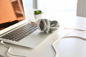Obraz na płótnie Canvas Laptop and headphones on office table