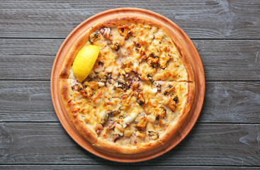 Delicious seafood pizza on grey wooden background