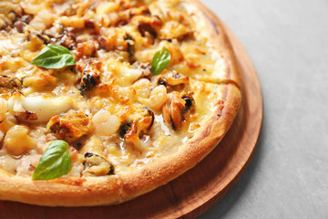 Tasty seafood pizza on grey background, close up