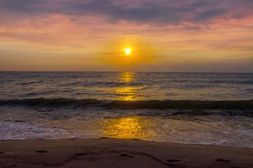 Sunset on the beach. Colorful dawn over the sea. Dramatic sky