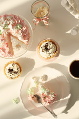 Tasty birthday cake, sweets and cup of coffee on table