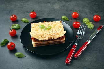 Portion of tasty lasagna on table