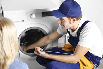 Plumber repairing washing machine