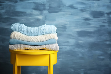 Pile of clothes on wooden stool