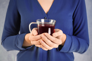 Young woman holding cup of tea, closeup