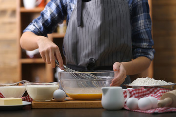 Obraz na płótnie Canvas Cooking concept. Woman making dough on kitchen