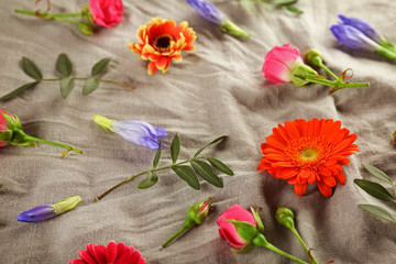 Flat lay of fresh flowers on textile background