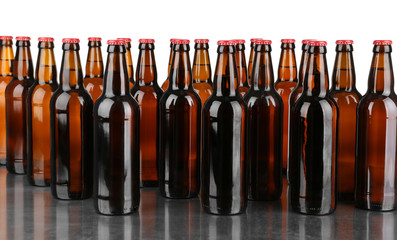 Bottles of beer on table against white background