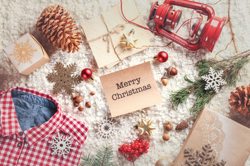 Fototapeta na wymiar Christmas decorations and wish card on soft fabric background