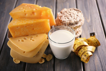Different dairy products on wooden background