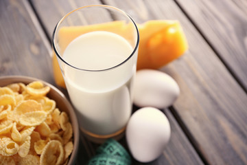 Different dairy products on wooden background