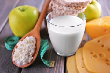 Different dairy products on wooden background