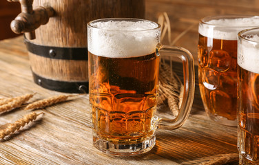 Glasses with beer on wooden background