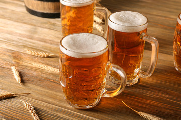 Glasses with beer on wooden background
