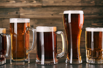 Glasses with beer on wooden background