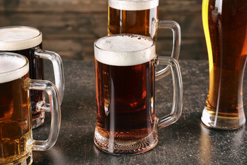 Glasses with beer on gray table