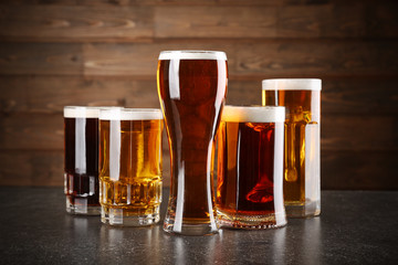Glasses with beer on wooden background