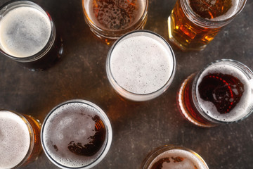 Glasses with beer on gray background