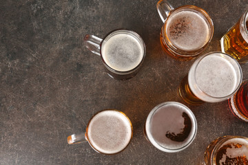 Glasses with beer on gray background