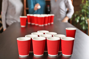 People playing Beer Pong on table at bar