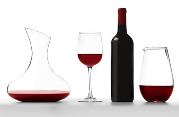 Glass carafe of red wine on white background