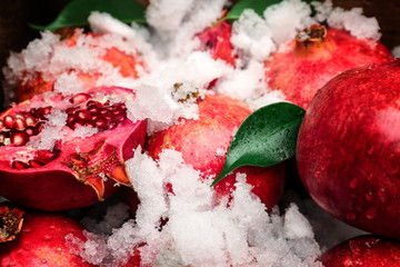 Pomegranates with snow, closeup