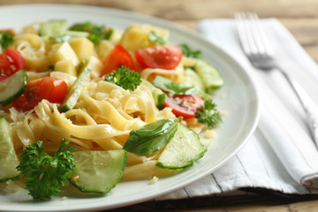 Plate of pasta salad with tomatoes and cucumber