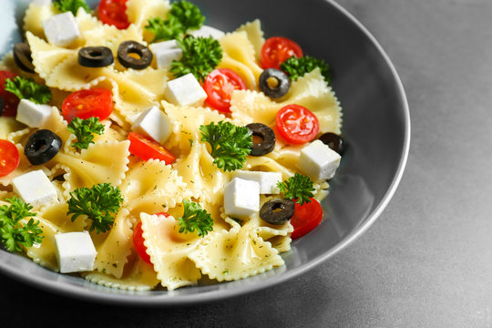 Pasta salad with tomatoes and cheese on table