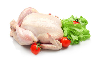 Whole raw chicken with lettuce and tomato on white background