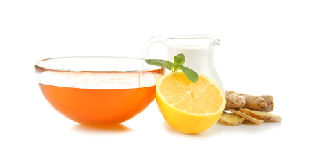 Natural medicine concept. Honey, lemon, milk and ginger on white background