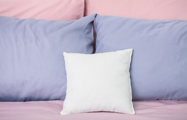 Blank pillow on bed in room