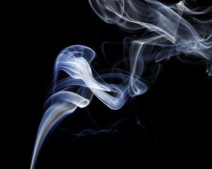Abstract art. Color white blue smoke from the aromatic sticks on a black background. Background for Halloween. Texture fog. Design element. The concept of aromatherapy.