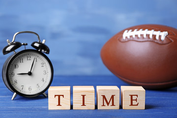Cubes with alarm clock and ball on color background. Time concept