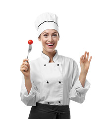 Portrait of female chef holding fork with cherry tomato isolated on white