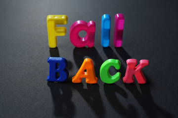 Phrase FALL BACK on chalkboard background