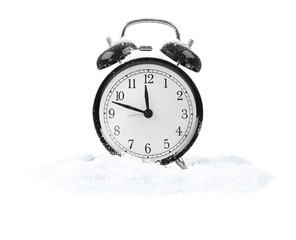 Alarm clock with snow isolated on white