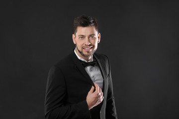 Fototapeta premium Handsome young man posing on dark background