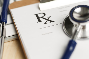 Prescription form clipped to pad lying on table © megaflopp