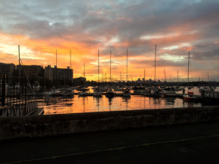 Sunset sky over city port with yachts