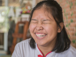 Happy Asian girl smilling in cafe.