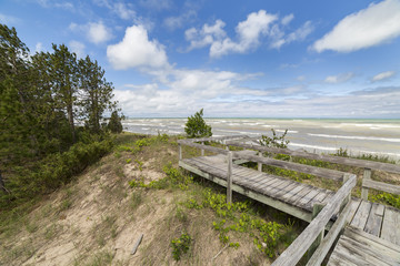 Fototapeta na wymiar Boardwalk through a sand dune ecosystem next to Lake Huron