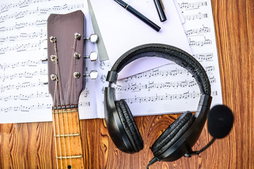 Plakat Music book, notepad pen headphone and acoustic guitar on old table