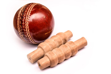 Cricket ball and bails on isolated white background