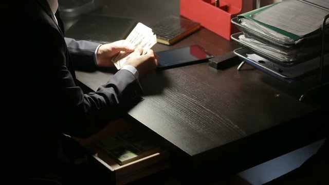 corruption, bribery and fraud concept - close up of businessman taking money