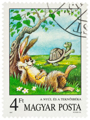 Scene from a fable "Tortoise and Hare" by Aesop on postage stamp © Vic