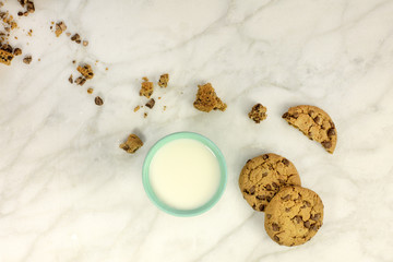 Chocolate chips cookies with crumbs, milk and copyspace