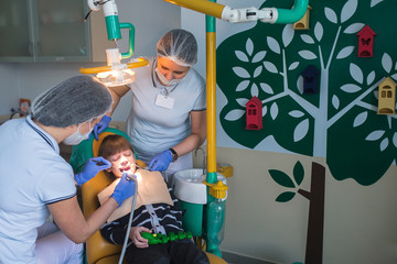 dentist and nurse curing childe teeth
