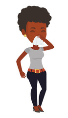 Young african-american sick woman sneezing.